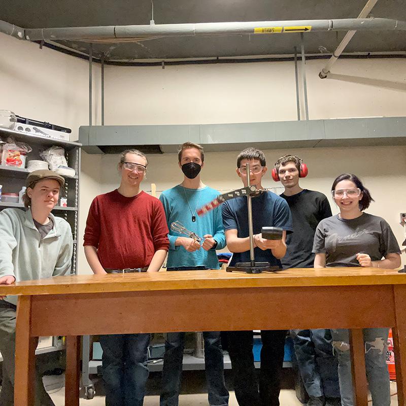 Students in the Society of Physics group pose for photo during an experiment